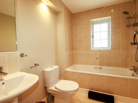 A bathroom with a bathtub, sink, and toilet at Trelawney House in Duporth near Charlestown