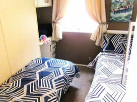 A bedroom with two beds and a window at Seton Sands Caravan Park - Holiday Accommodation 13391 Cockenzie And Port Seton