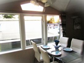 A dining room with a table set for meals at Seton Sands Caravan Park - Holiday Accommodation 13391 Cockenzie And Port Seton