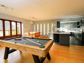 A game room with a pool table and dining table at Lady Of Lourdes in Whitchurch, Herefordshire