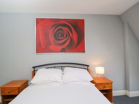 A bedroom with a bed and nightstands at Lady Of Lourdes, Whitchurch, Herefordshire
