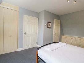 A bedroom with a bed and wardrobe at Lady Of Lourdes in Whitchurch, Herefordshire