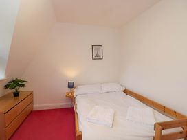 A bedroom with a bed and dresser at Lady Of Lourdes Whitchurch, Herefordshire