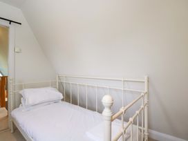 A bedroom with a single bed and pillows at Lady Of Lourdes in Whitchurch, Herefordshire
