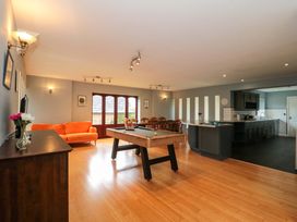 A living room with a sofa and pool table at Lady Of Lourdes in Whitchurch, Herefordshire
