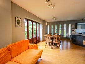 A living room with a sofa and dining area at Lady Of Lourdes Whitchurch, Herefordshire