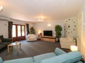 A living room with a sofa and television at Lady Of Lourdes Whitchurch, Herefordshire