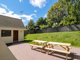 An outdoor area with picnic tables and a house at Lady Of Lourdes Whitchurch, Herefordshire