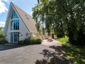 A house with a table and trees at Lady Of Lourdes in Whitchurch, Herefordshire