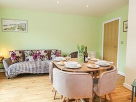 A dining area with a table set for meals at Rodwell Holt in Weymouth