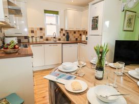 A kitchen with a table set for dining at Rodwell Holt in Weymouth