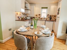 A kitchen with a dining table and chairs at Rodwell Holt in Weymouth