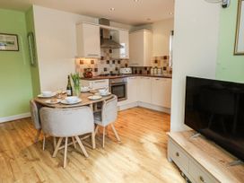 A dining room with a table set for meals at Rodwell Holt in Weymouth