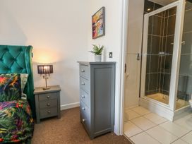 A bedroom with a bed and shower cubicle at Rodwell Holt in Weymouth