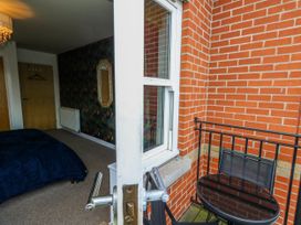 A bedroom with a bed and balcony in Rodwell Holt Weymouth