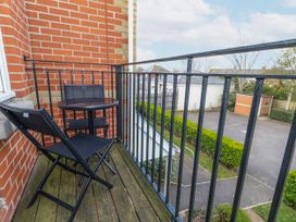 A balcony with a table and chair at Rodwell Holt in Weymouth
