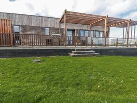 An outdoor area with wooden decking and a pergola at Adelaide in Redruth