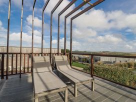 A deck with sun loungers and a view at Adelaide in Redruth