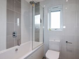 A bathroom with a bathtub and a toilet at Adelaide in Redruth