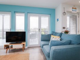 A living room with a television and sofa at Adelaide in Portreath