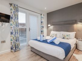 A bedroom with a bed and a television at Adelaide in Portreath