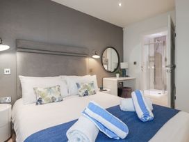 A bedroom with a bed and shower at Adelaide in Portreath