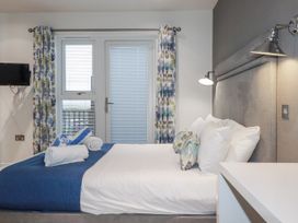 A bedroom with a bed and window at Adelaide in Portreath