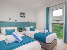A bedroom with two beds and a window at Adelaide in Portreath