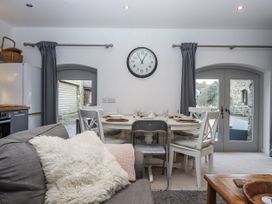A dining room with a table and chairs at Clifford Lodge Barn