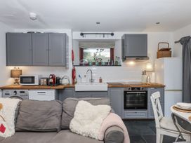 A kitchen with cabinets and appliances at Clifford Lodge Barn