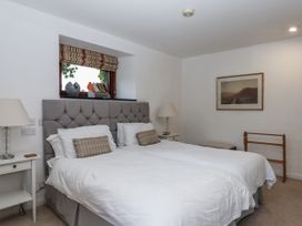A bedroom with two beds and a nightstand at Clifford Lodge Barn 
