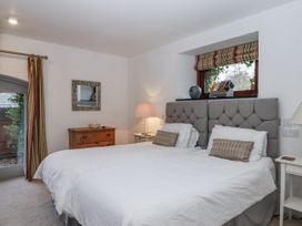 A bedroom with a bed and nightstand at Clifford Lodge Barn