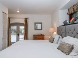 A bedroom with two beds and a window at Clifford Lodge Barn