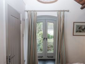 A bedroom with a window and curtains at Clifford Lodge Barn