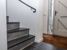 A staircase with a handrail and an open door at Clifford Lodge Barn