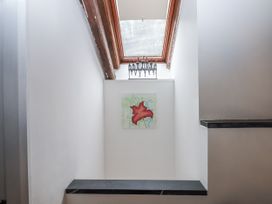 A stairwell with an artwork on the wall and a skylight at Clifford Lodge Barn