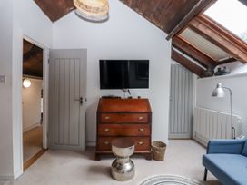 A living room with a television and chest of drawers at Clifford Lodge Barn