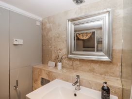A bathroom with a sink and mirror at Clifford Lodge Barn