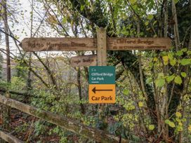 A signpost with directional information at Clifford Lodge Barn