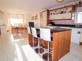 A kitchen with a dining area and modern furniture at Storey and Half House in Annagry