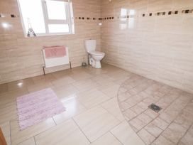 A bathroom with a toilet and towel at Storey and Half House Annagry
