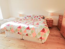 A bedroom with a bed and nightstand at Storey and Half House in Annagry