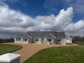 A house with a garage and driveway at Storey and Half House near Annagry, County Donegal