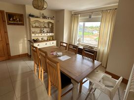 A dining room with a table and chairs at Storey and Half House Near Annagry, County Donegal