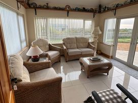 A conservatory with seating area at Storey and Half House Near Annagry, County Donegal