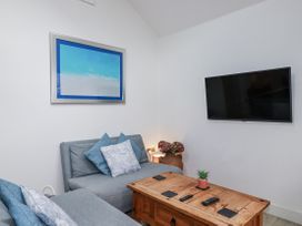 A living room with a sofa and coffee table at Cove Retreat in Penzance