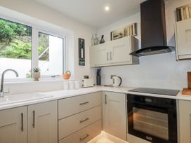 A kitchen with cabinets and appliances at Cove Retreat in Penzance
