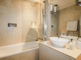 A bathroom with a bathtub and sink at Cove Retreat in Penzance