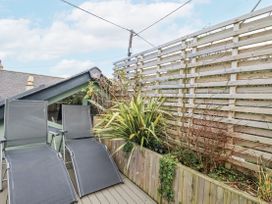 An outdoor area with deck chairs and a planter at Cove Retreat in Penzance