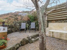 A garden with chairs and gravel at Cove Retreat in Penzance